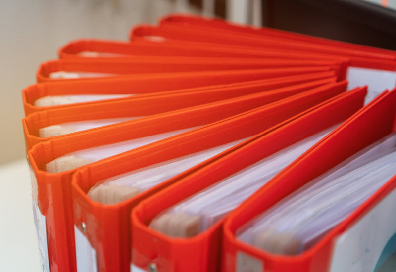 Red Files folder on office desk