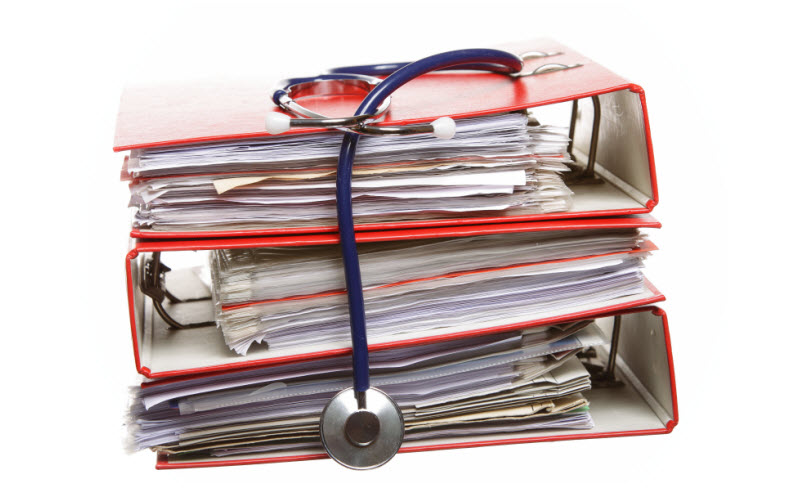 Stack of red file folders with blue stethoscope